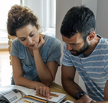 Couple looking at home improvement documents