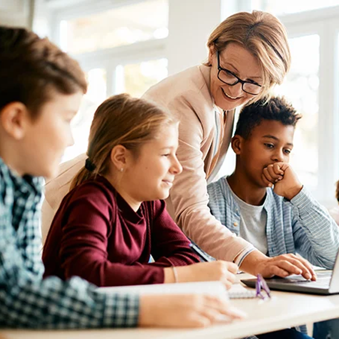 Teacher helping students