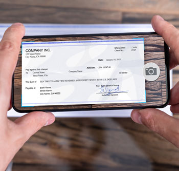 Person using smartphone to deposit a check