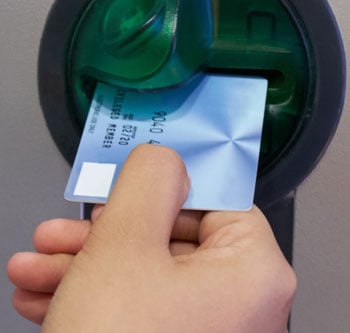 Debit card being inserted into ATM 