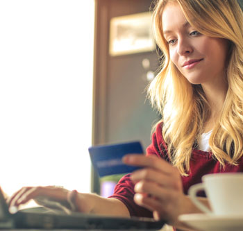 Woman using credit card to buy something online