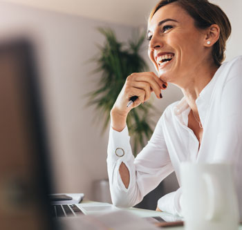 Smiling woman holds a pen