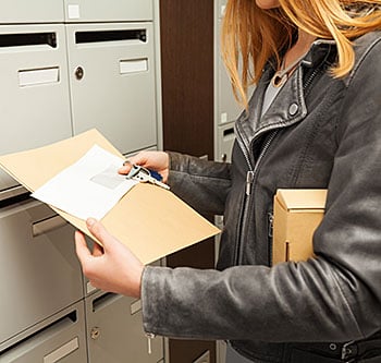 Woman looking at envelope and folder