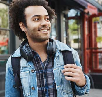 Man wearing headphones and a backpack