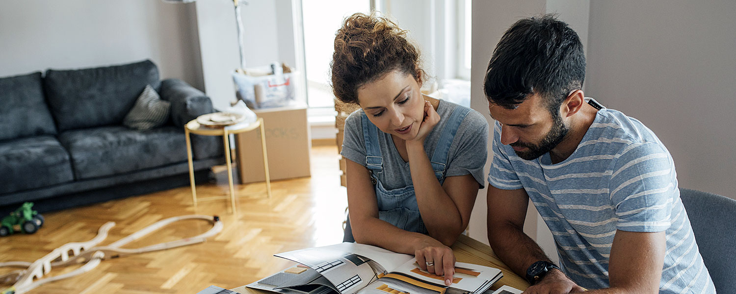 Couple looking at home improvement documents