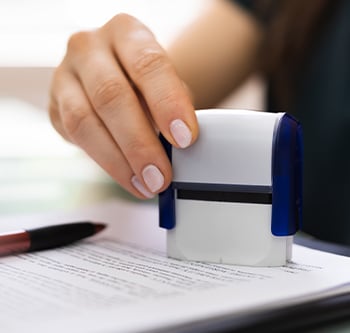 Notary stamping a piece of paper