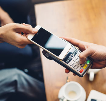 Person paying at retail with smartphone