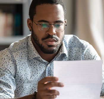 Man looking at piece of paper