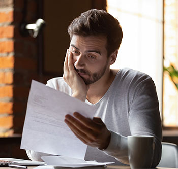 Man staring at piece of paper