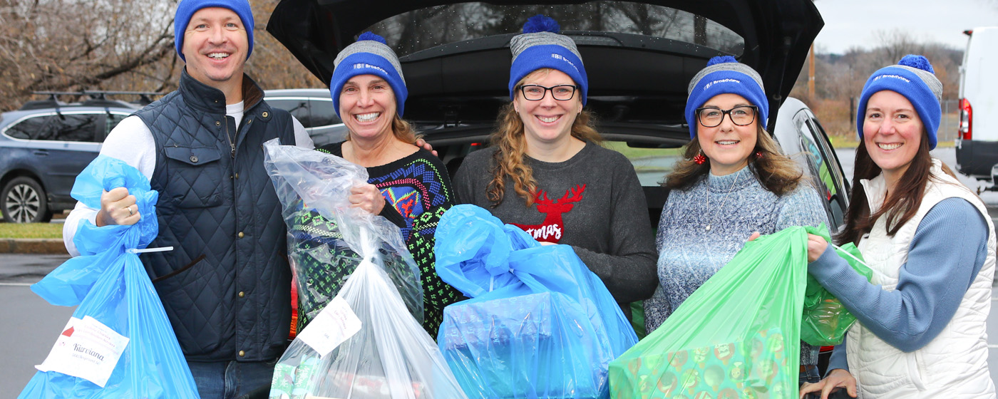 Group of Broadview employees volunteering and wearing matching Broadview beanies