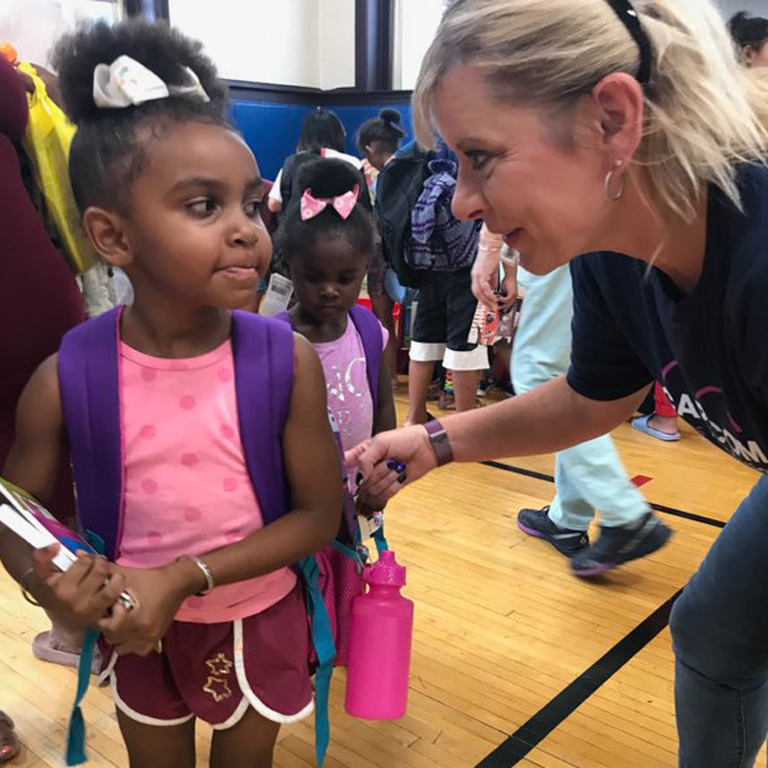 CAP COM volunteer helps a school child