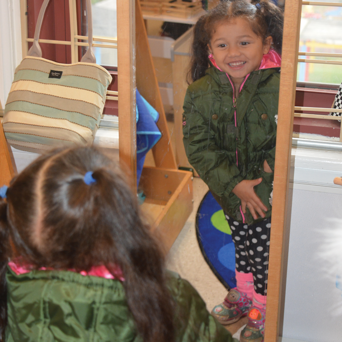 Girl standing in front of mirror with new coat