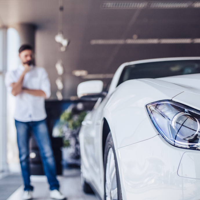 Man looking at white car