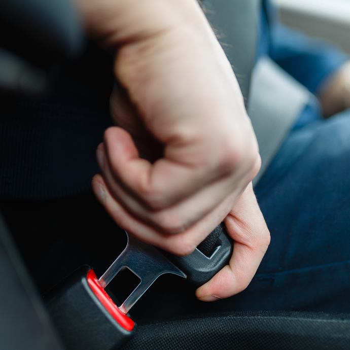 Person buckling their seatbelt