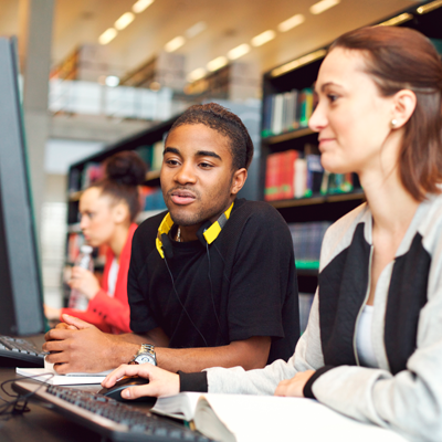 Student looking at computer with another student