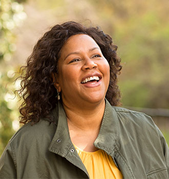 A black woman taking a walk outside in the fall.