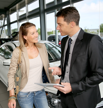 A woman shopping for cars at a dealership