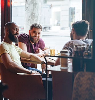 Three men sitting together having a drink