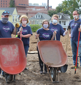 CAP COM Cares volunteers gardening at Capital Roots