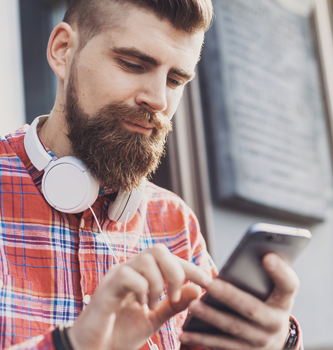 Bearded man scrolling on his phone