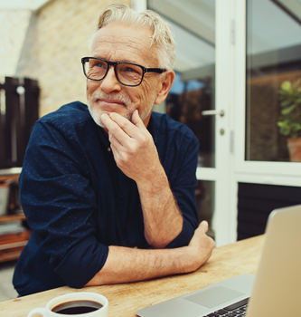 Older man wearing dark glasses and thinking