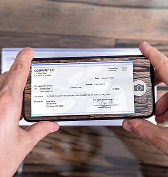 A person depositing a check with their smartphone