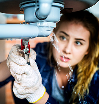 Woman fixing water leak