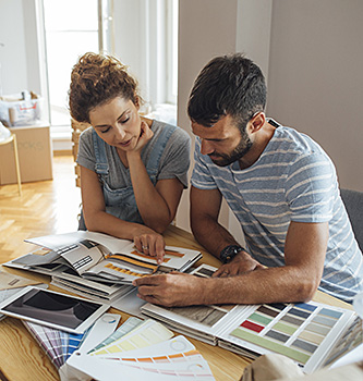 Couple looking at different paint colors in a book