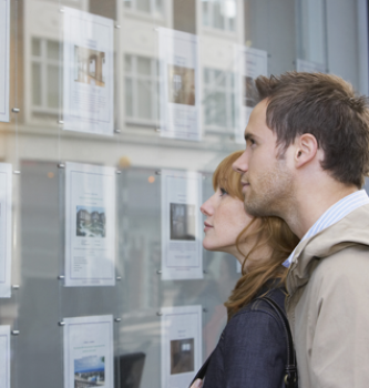 man and woman looking at pictures of homes