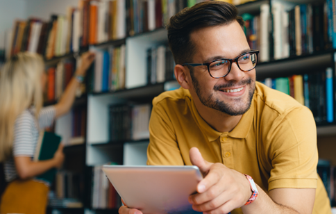 Man smiling in a bookstore