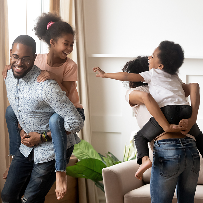 Parents holding their kids on their back